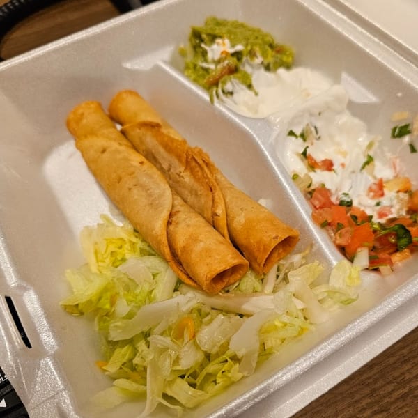 Sergio's Mexican Restaurant's taquitos with shredded lettuce, guacamole, sour cream, and pico de gallo.